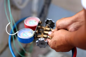 man with manometers measuring equipment for blog on update on the 401a Refrigerant Change blog