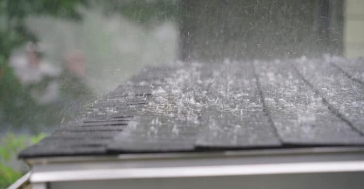 protecting your plumbing system from summer storms blog image of heavy rain on roof